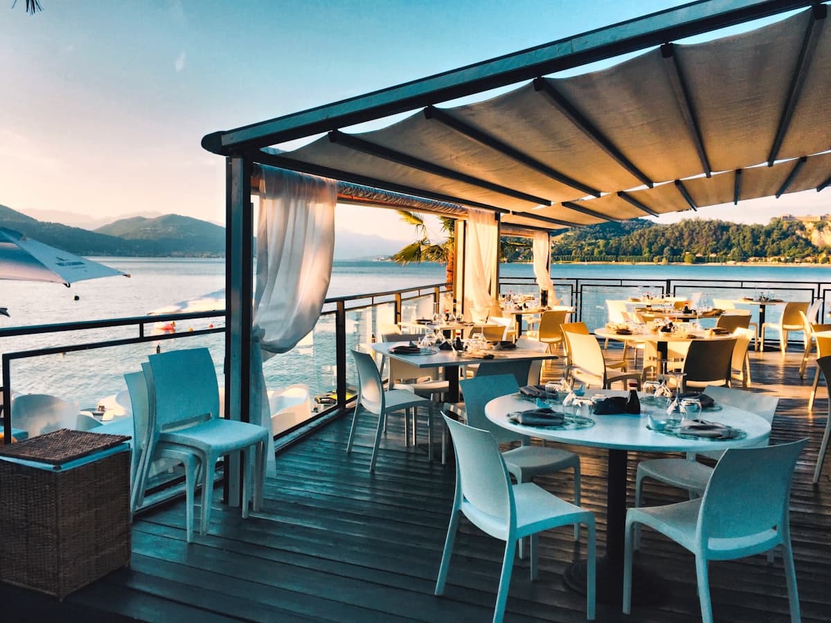 A lakeside restaurant terrace at sunset